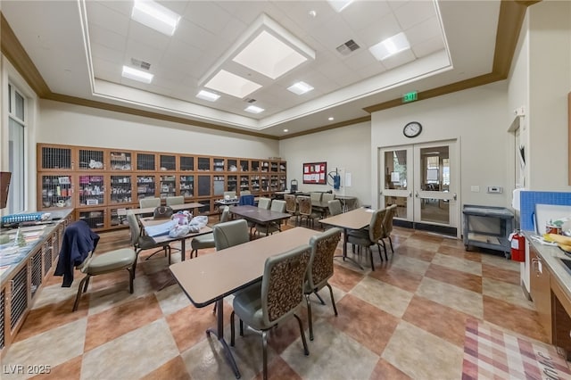 dining space featuring visible vents, a tray ceiling, ornamental molding, and french doors