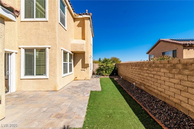 view of yard featuring a patio and a fenced backyard