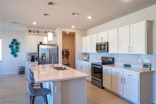4400 E Cactus Canyon Dr, Pahrump, NV 89061 - kitchen with visible vents, a breakfast bar area, appliances with stainless steel finishes, and a sink