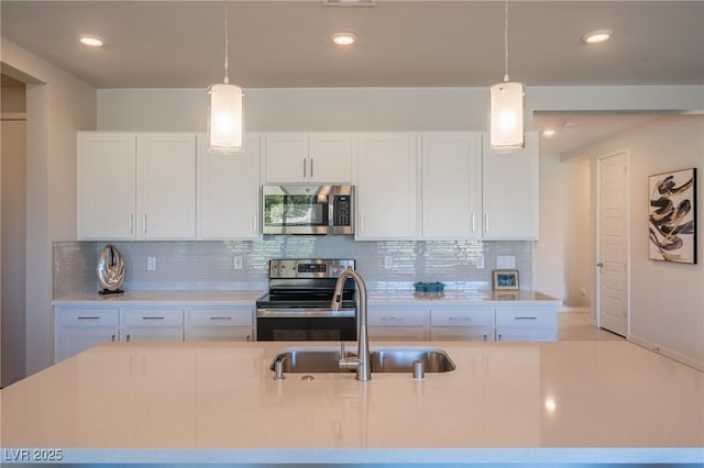 4400 E Cactus Canyon Dr, Pahrump, NV 89061 - kitchen with appliances with stainless steel finishes, light countertops, a sink, and white cabinetry