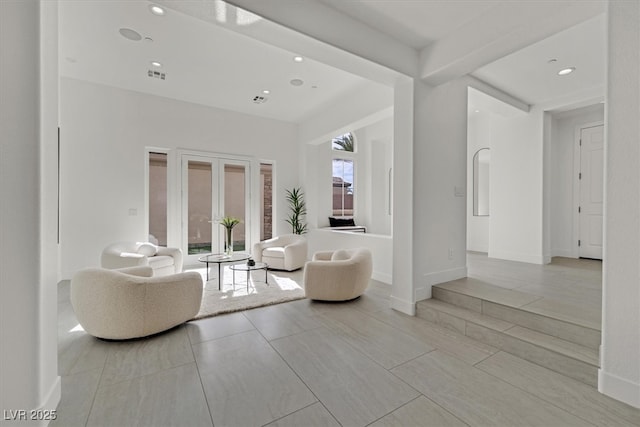 living area featuring recessed lighting, visible vents, and baseboards