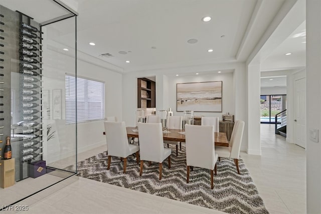 tiled dining area featuring baseboards, visible vents, and recessed lighting