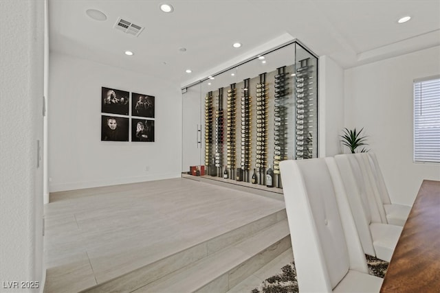 wine cellar featuring visible vents, wood finished floors, and recessed lighting