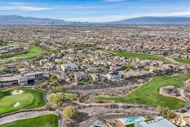 drone / aerial view featuring a residential view, a mountain view, and golf course view