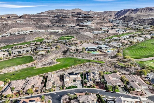 drone / aerial view featuring a mountain view, view of golf course, and a residential view