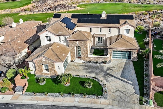 view of front of home featuring an attached garage, stone siding, concrete driveway, and stucco siding