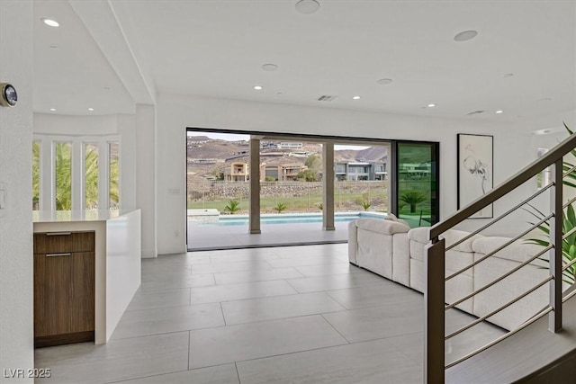 interior space featuring recessed lighting, a healthy amount of sunlight, and visible vents