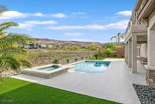 view of pool with a fenced in pool, a patio, a fenced backyard, an in ground hot tub, and a mountain view