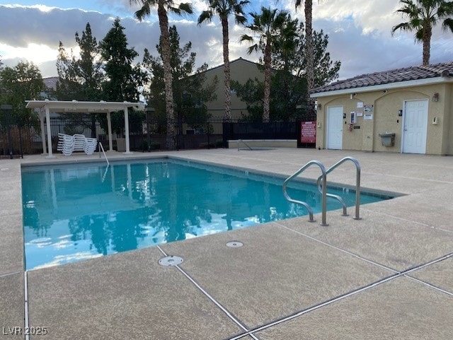 pool featuring a patio area and fence