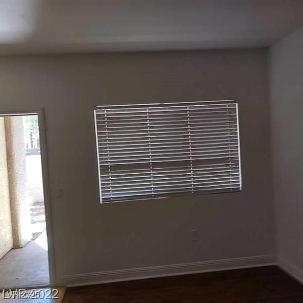 unfurnished room with baseboards