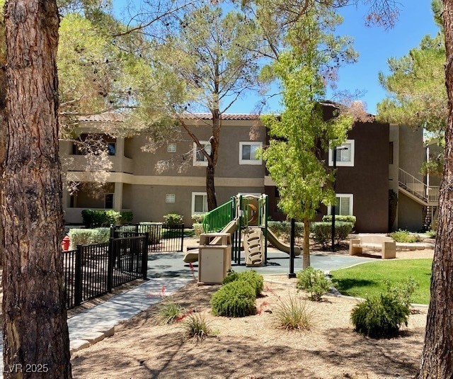 view of community with playground community and fence