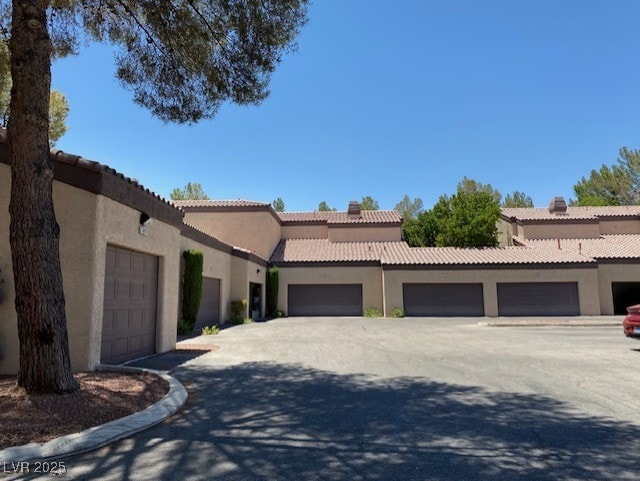 mediterranean / spanish-style house featuring a tile roof and stucco siding