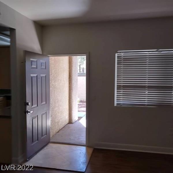 foyer with wood finished floors and baseboards