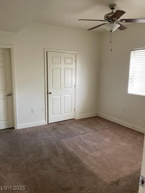 unfurnished bedroom featuring ceiling fan, baseboards, and carpet flooring