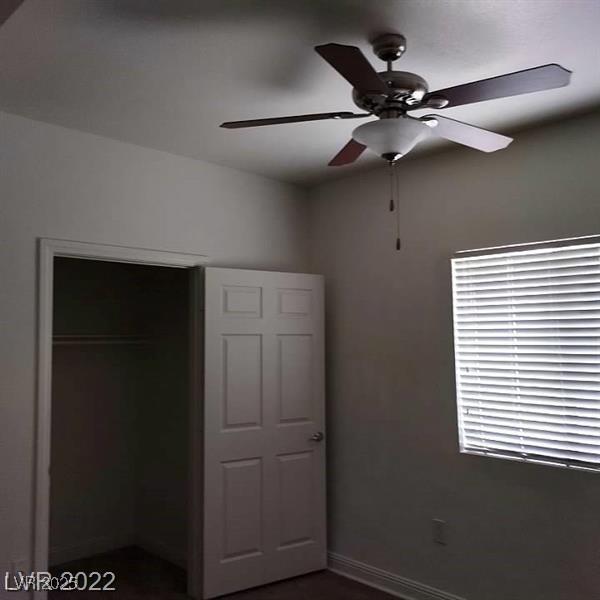 unfurnished bedroom with baseboards and a ceiling fan