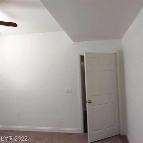 unfurnished room with baseboards