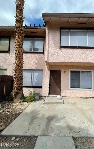 exterior space with fence and stucco siding