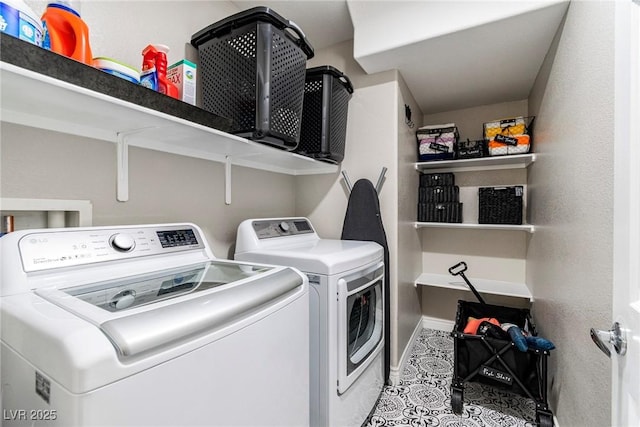 washroom featuring laundry area, washer and clothes dryer, and baseboards