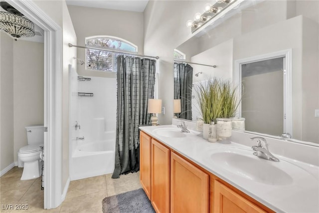 full bathroom with shower / tub combo with curtain, a sink, toilet, and tile patterned floors