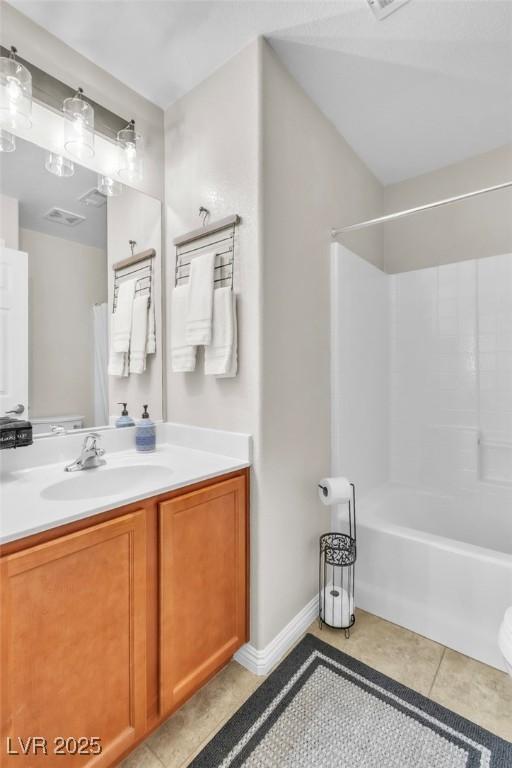 full bath featuring bathing tub / shower combination, visible vents, vanity, tile patterned flooring, and baseboards