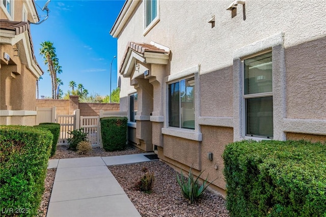 view of home's exterior featuring fence and stucco siding