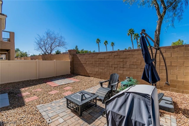 view of patio with a fenced backyard and area for grilling