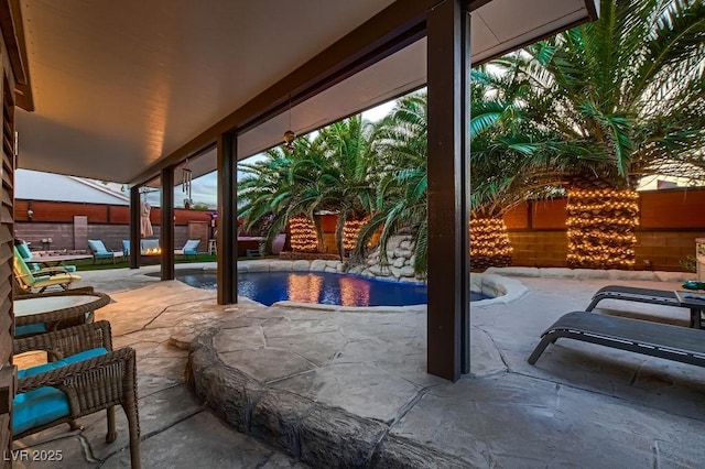 view of patio featuring a fenced in pool and fence