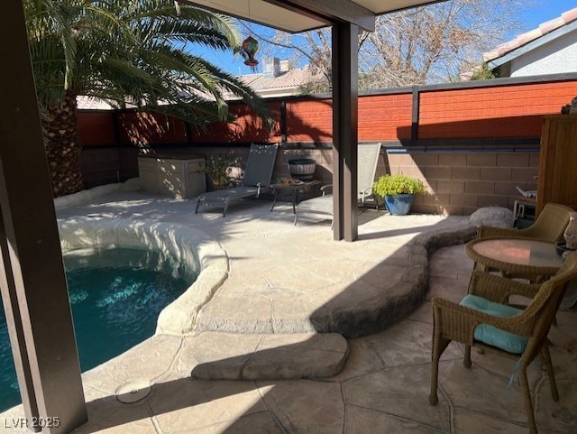 view of patio / terrace featuring a pool and a fenced backyard