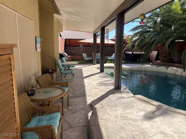 view of swimming pool featuring a fenced in pool, a patio, and fence