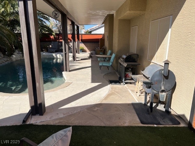 view of patio featuring an outdoor pool and a grill