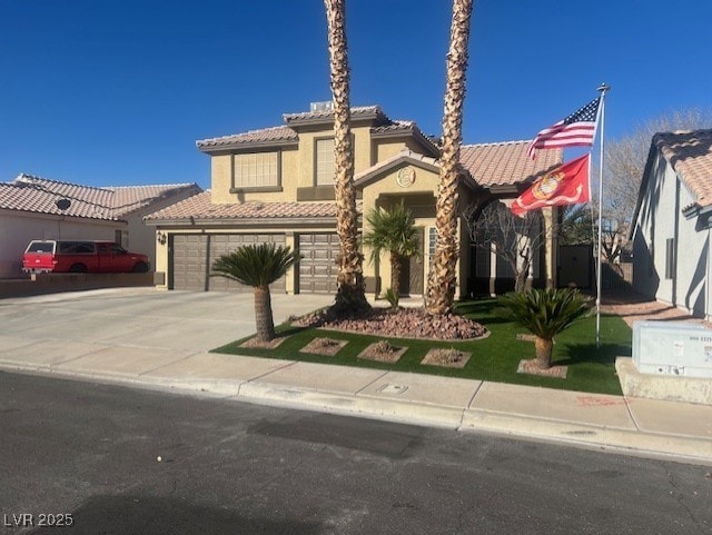 view of front of home featuring stucco siding, concrete driveway, and a tile roof