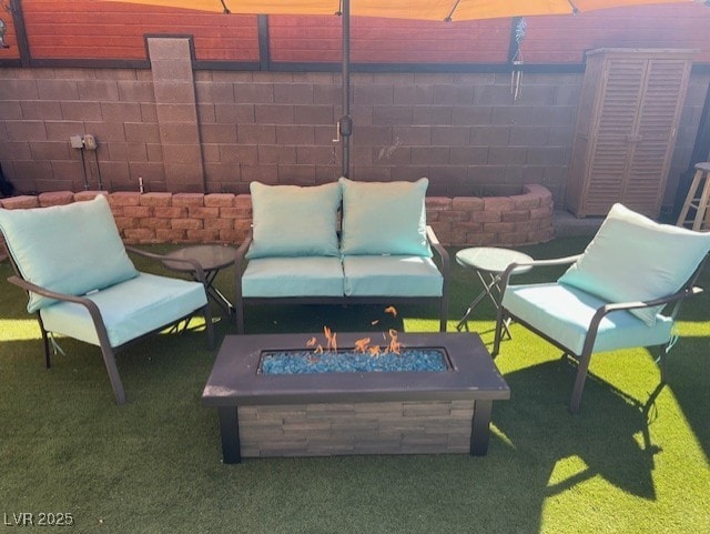 view of patio / terrace featuring a fire pit and fence