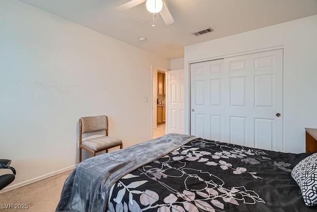 bedroom with baseboards, visible vents, ceiling fan, a closet, and light carpet