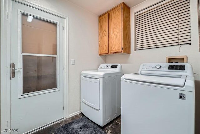 laundry area with cabinet space and independent washer and dryer