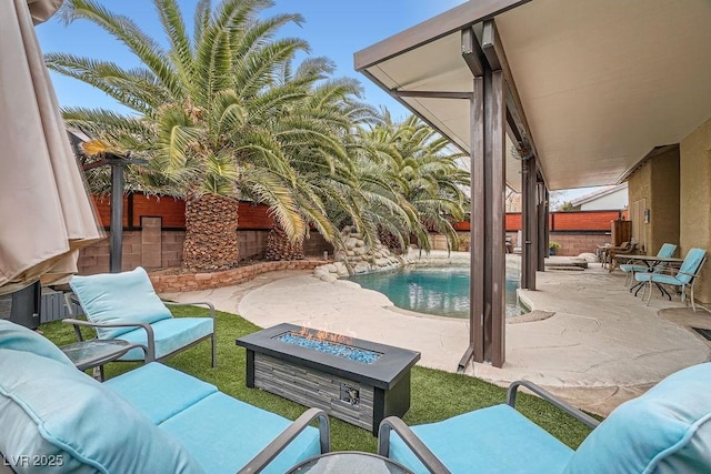 view of patio / terrace with a fenced in pool, an outdoor living space with a fire pit, and a fenced backyard