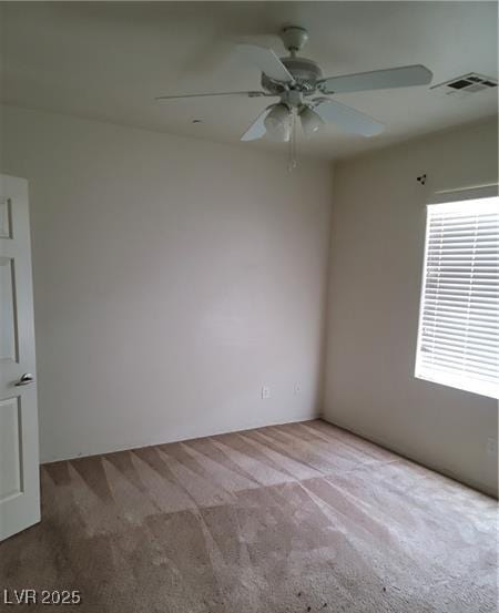 empty room featuring a ceiling fan, carpet, and visible vents