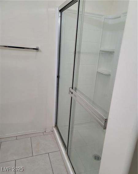 full bathroom featuring a stall shower and tile patterned floors