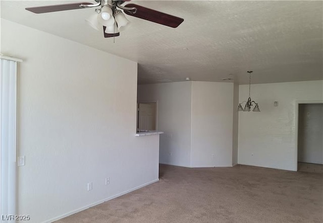 carpeted spare room with a textured ceiling and a ceiling fan