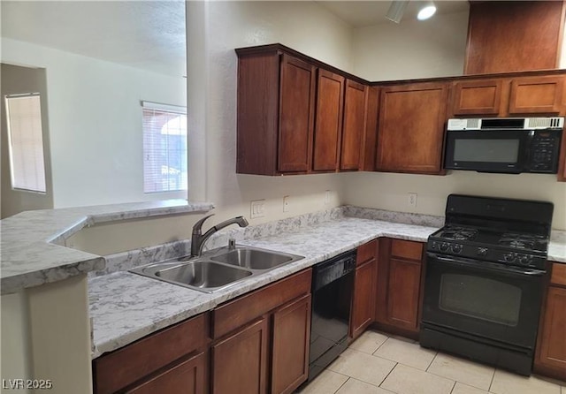 kitchen with light tile patterned floors, black appliances, a sink, and light countertops