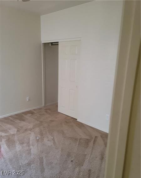 unfurnished bedroom featuring carpet and a closet