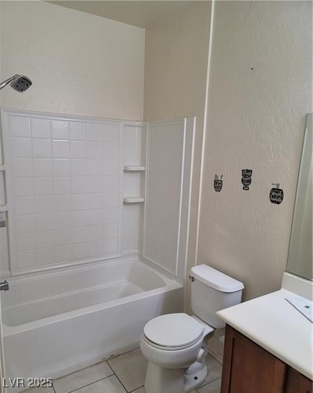 bathroom featuring bathtub / shower combination, a textured wall, toilet, vanity, and tile patterned flooring