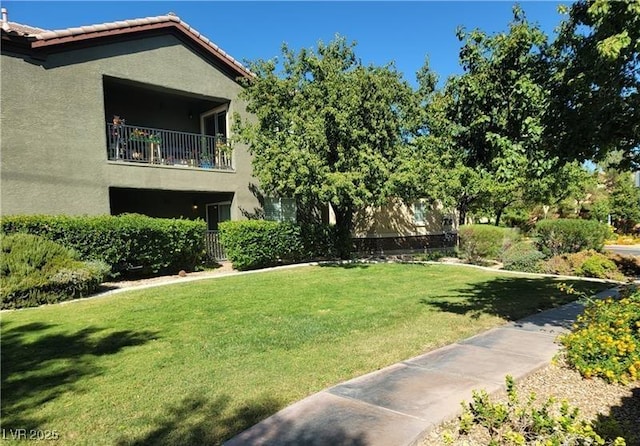 view of yard with a balcony