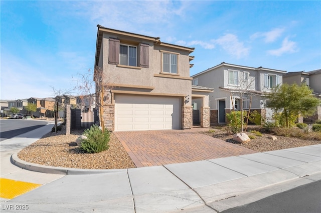 view of front of home with decorative driveway, a residential view, stone siding, and stucco siding