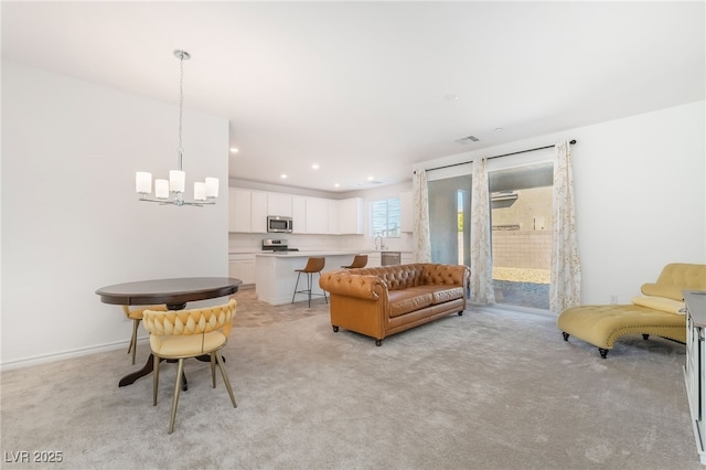 living room with a chandelier, recessed lighting, visible vents, and light colored carpet