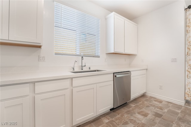 kitchen featuring a sink, white cabinetry, baseboards, light countertops, and dishwasher