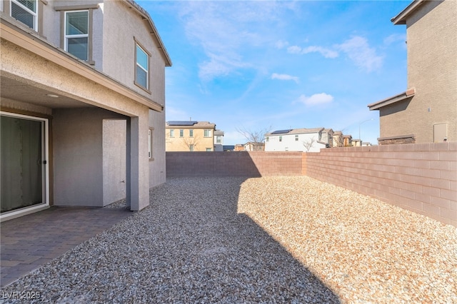 view of yard with a fenced backyard and a patio