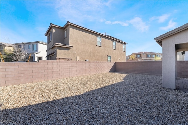 view of yard featuring a fenced backyard and a residential view