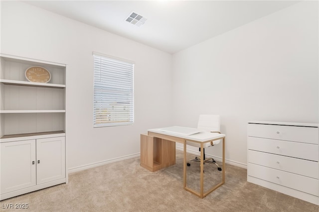 office space featuring visible vents, light carpet, and baseboards