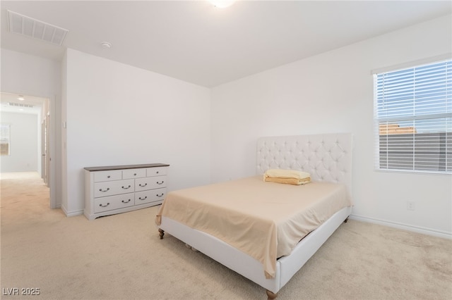 carpeted bedroom with visible vents and baseboards