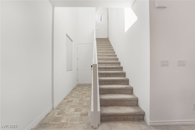 stairway featuring baseboards